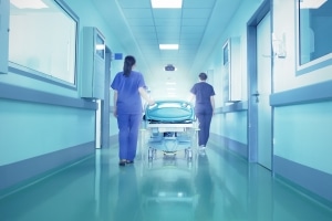 Nurses transporting a patient in a hospital hallway