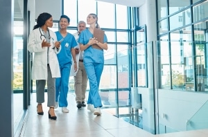Group of smiling medical professionals in a hallway