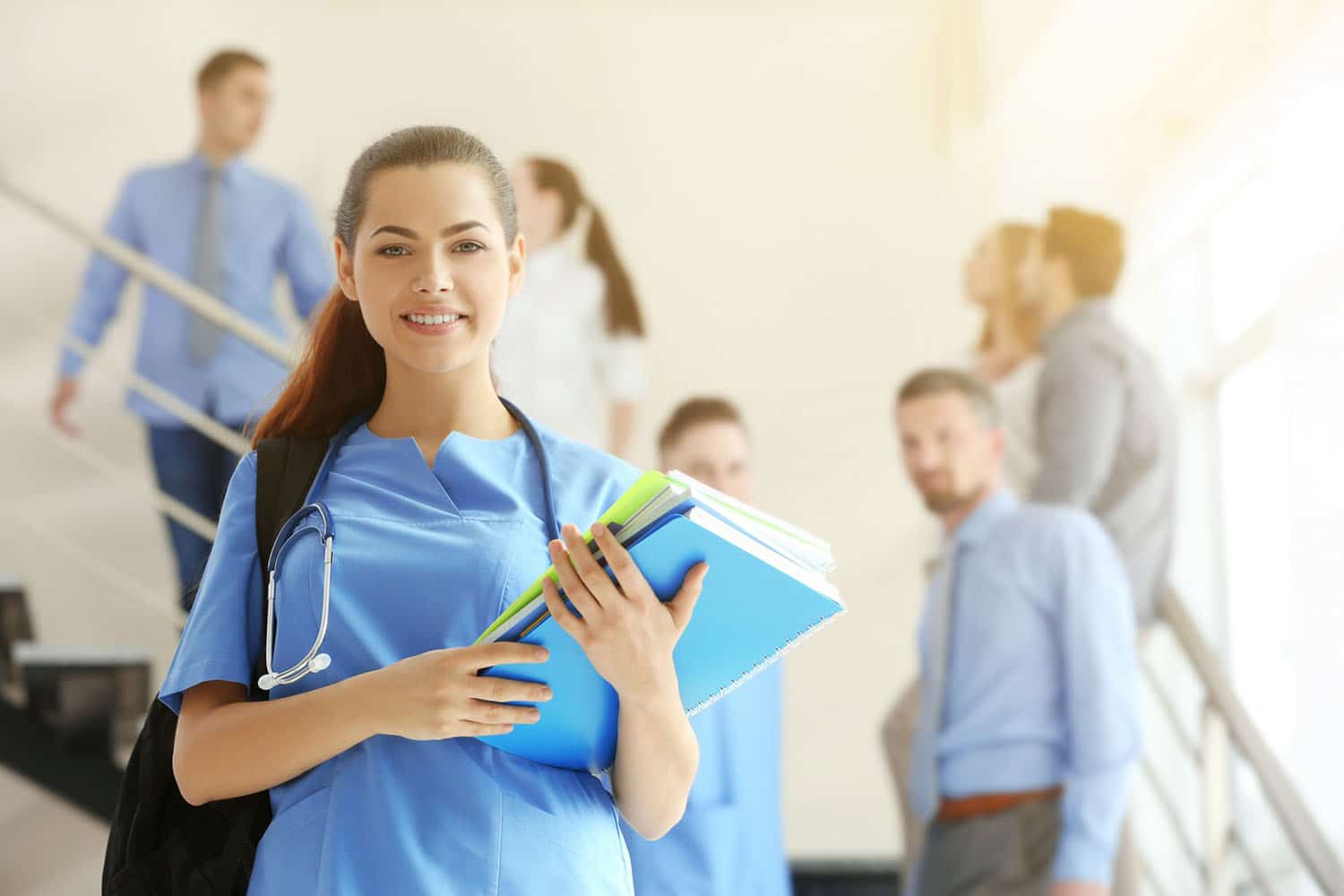 Young medical student standing in a stairwell